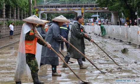 cleaning mud China|Workers clean up mud.